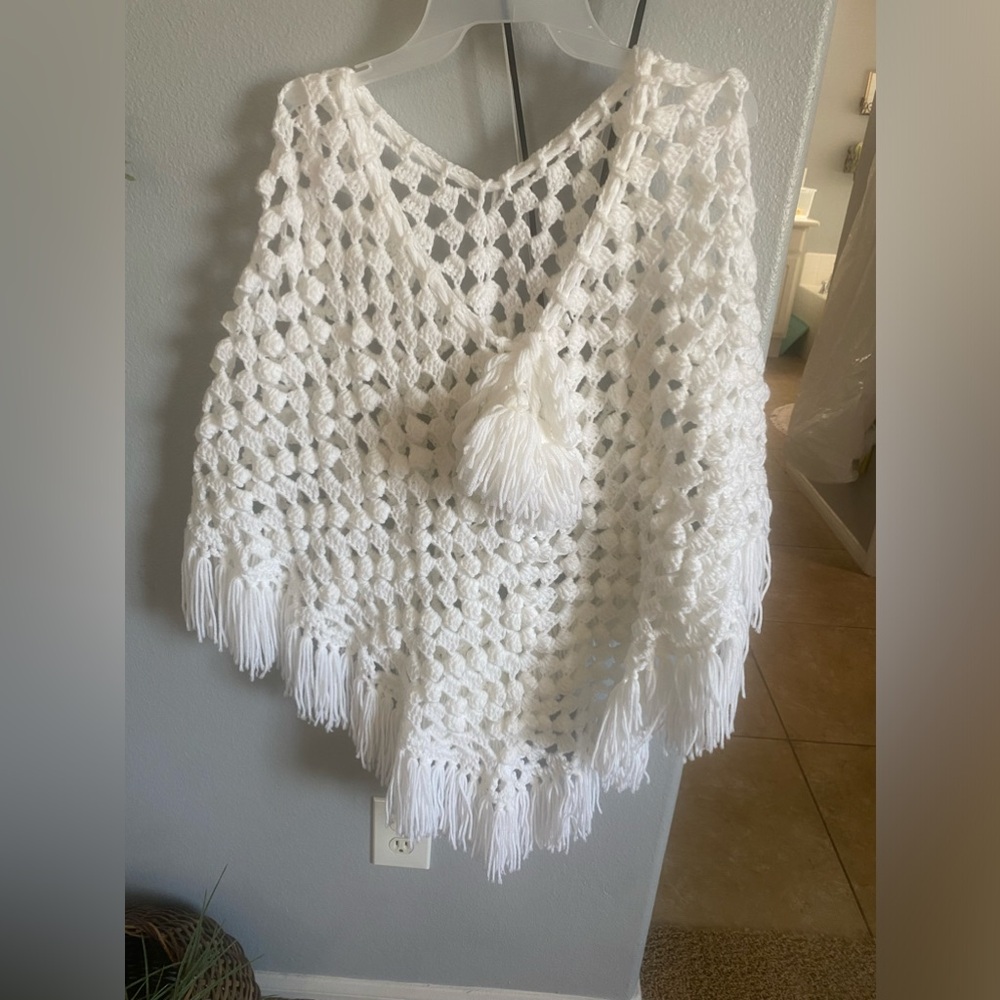 White crochet cape.